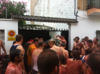 Locals washing off some participants with a hose.